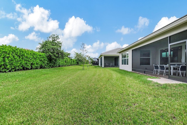 view of yard featuring a sunroom