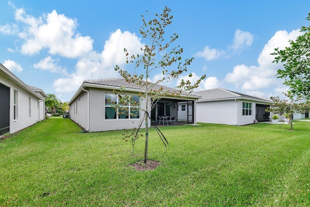 rear view of property with a lawn