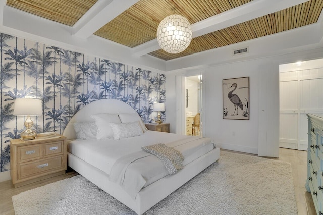 bedroom featuring connected bathroom, light wood-style flooring, visible vents, wood ceiling, and beamed ceiling