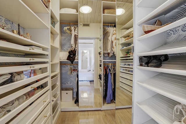 spacious closet featuring light wood-style flooring and visible vents