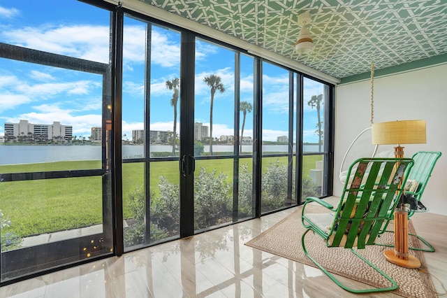 sunroom / solarium featuring a water view and a city view