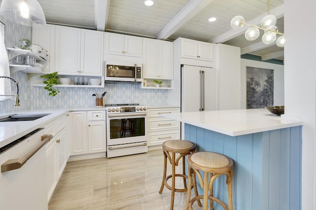 kitchen with a breakfast bar, open shelves, light countertops, white cabinetry, and white appliances