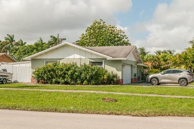 view of side of home featuring a lawn