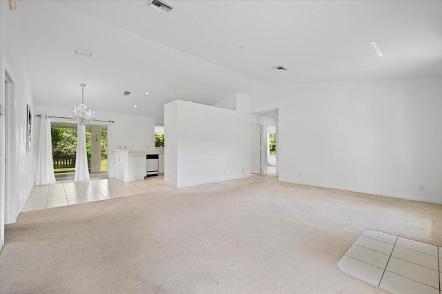 kitchen featuring white electric stove, vaulted ceiling, light tile patterned floors, and a notable chandelier