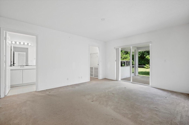 carpeted spare room with vaulted ceiling