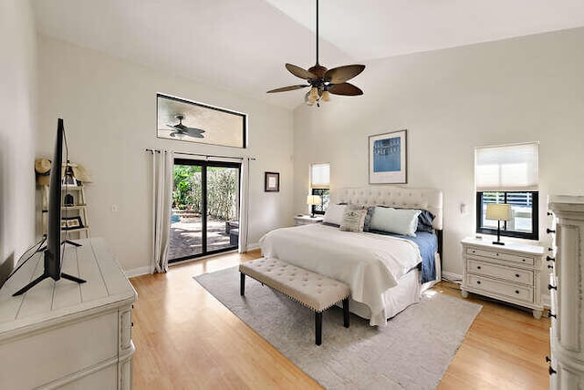 bedroom with ceiling fan, light hardwood / wood-style flooring, access to exterior, and high vaulted ceiling