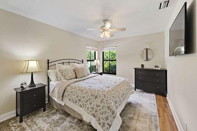 bedroom with ceiling fan and hardwood / wood-style floors