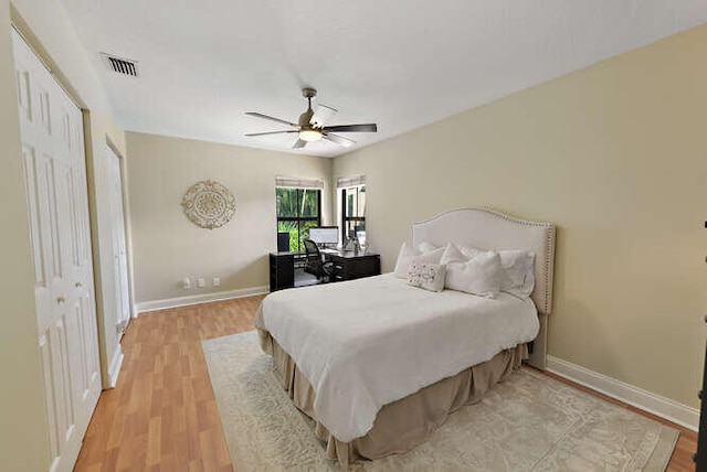 bedroom featuring ceiling fan, a closet, and light hardwood / wood-style flooring