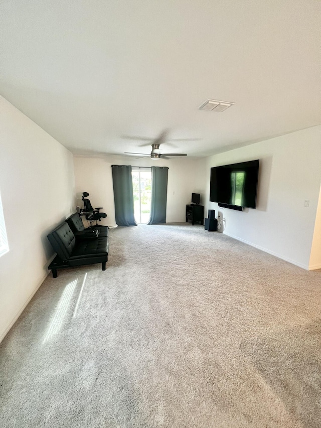 unfurnished room featuring visible vents, carpet floors, and ceiling fan