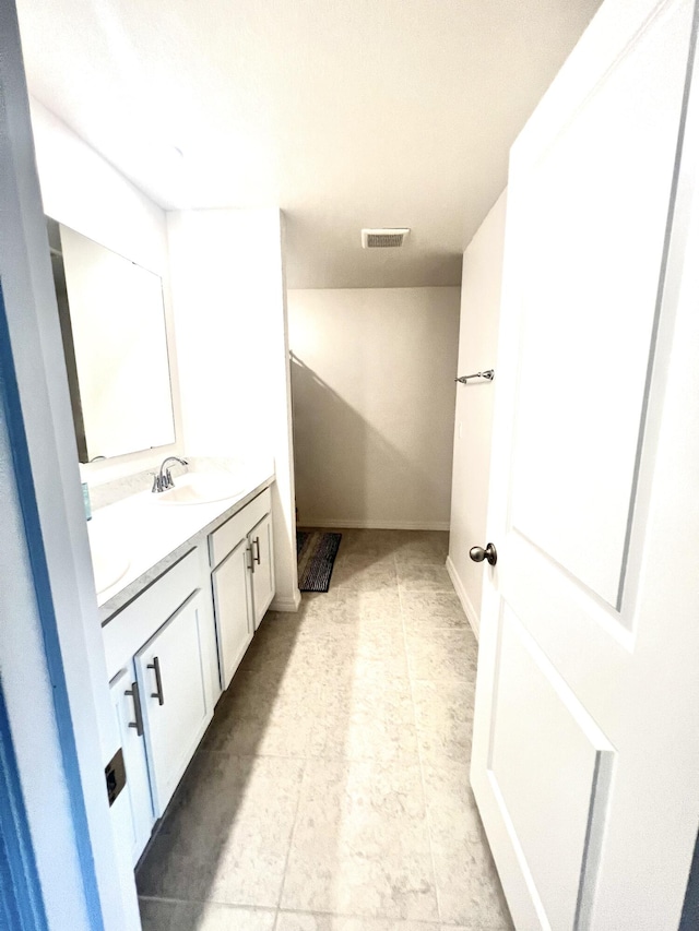 bathroom with vanity and tile patterned flooring