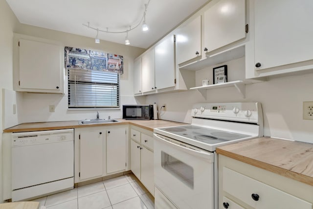 kitchen featuring white cabinetry, white appliances, sink, and light tile patterned flooring