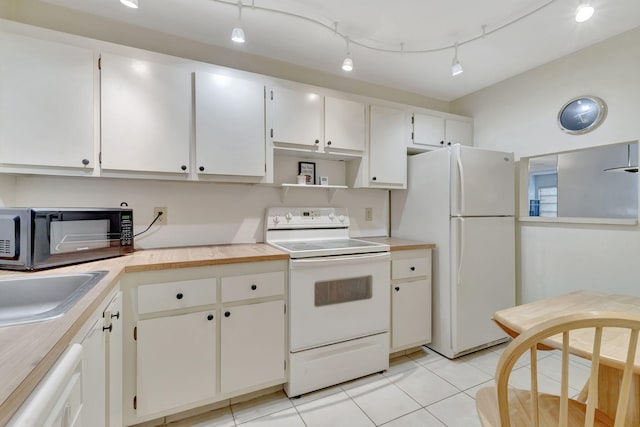 kitchen with white cabinetry, sink, rail lighting, light tile patterned floors, and white appliances