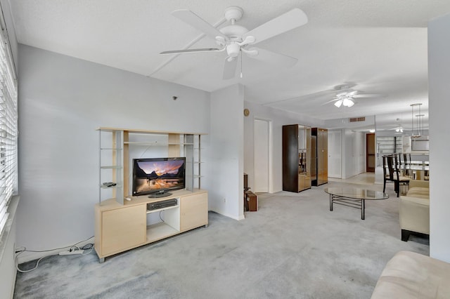 carpeted living room featuring ceiling fan