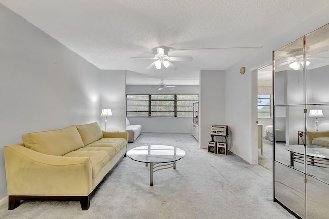 living room featuring a textured ceiling and light carpet