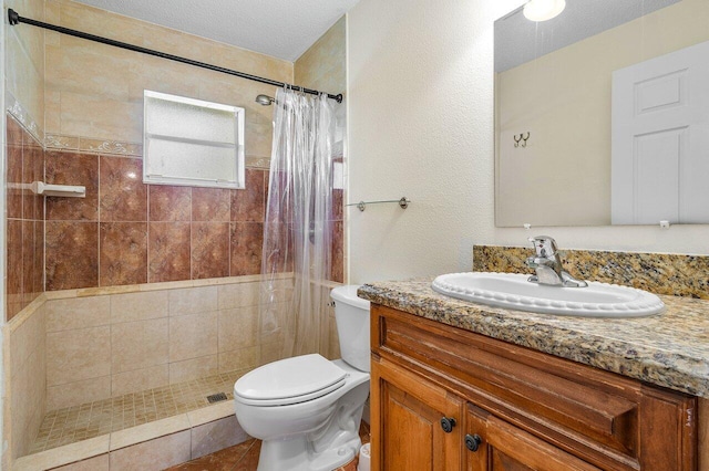 bathroom with vanity, toilet, walk in shower, and a textured ceiling