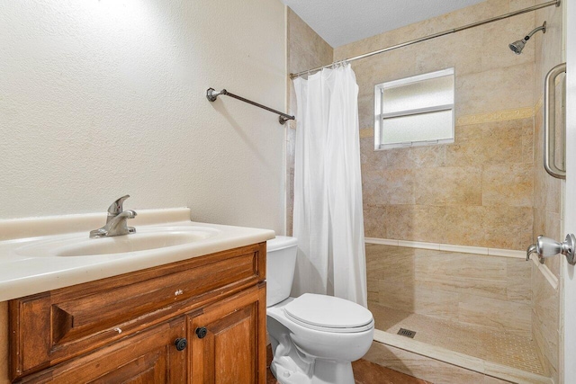 bathroom with vanity, toilet, and walk in shower