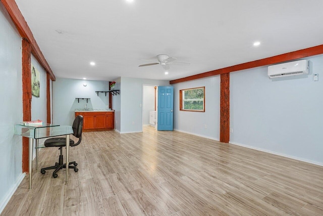 office with an AC wall unit, light wood-type flooring, and ceiling fan