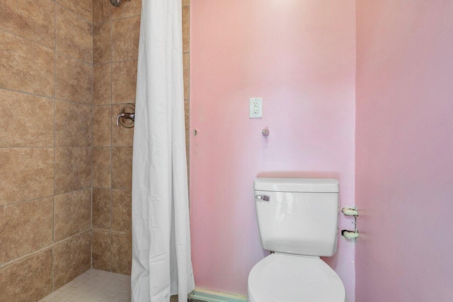 bathroom featuring toilet and walk in shower