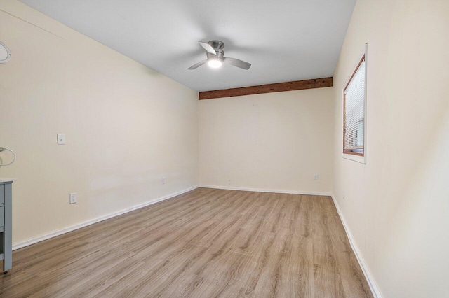 unfurnished room featuring light hardwood / wood-style floors, beam ceiling, and ceiling fan