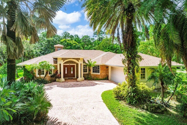 mediterranean / spanish-style home featuring a garage