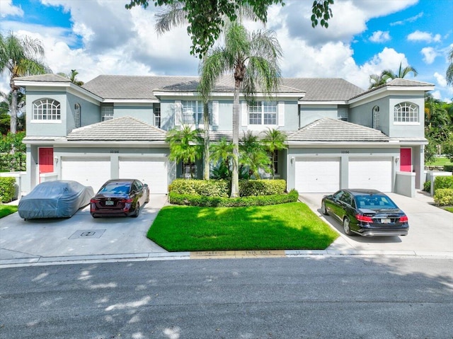 front of property with a garage and a front yard