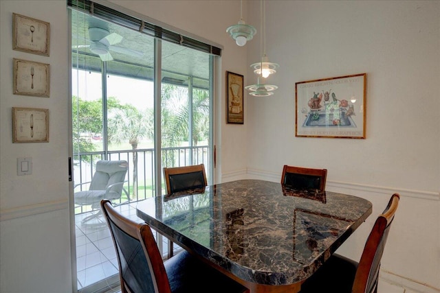 dining area featuring ceiling fan and tile patterned floors