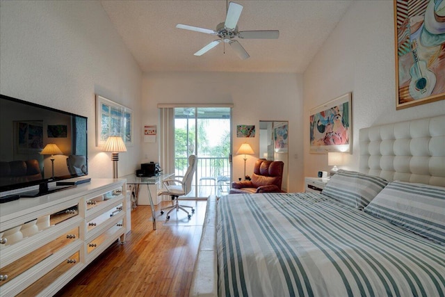 bedroom featuring a textured ceiling, access to outside, light hardwood / wood-style floors, and ceiling fan