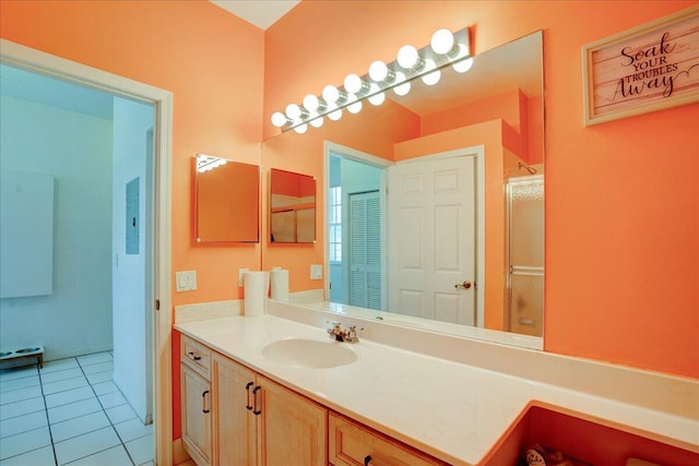 bathroom with vanity, a shower with shower door, and tile patterned flooring