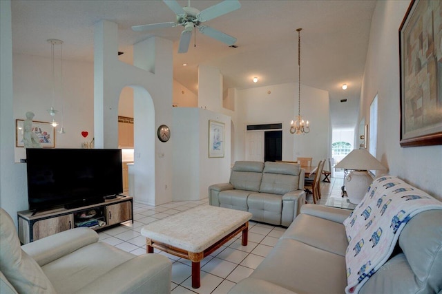 living room with light tile patterned flooring, ceiling fan with notable chandelier, and high vaulted ceiling