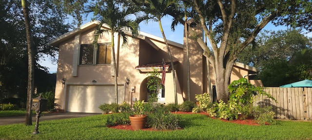 view of front of property featuring a front yard and a garage