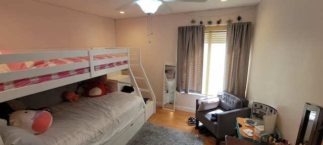 bedroom with light hardwood / wood-style floors and ceiling fan