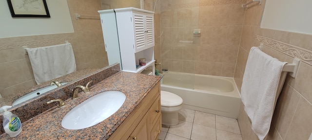 full bathroom featuring tile walls, vanity, toilet, and tile patterned floors