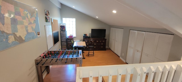 interior space featuring wood-type flooring and lofted ceiling