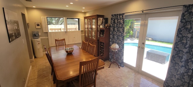 dining space with light tile patterned floors and french doors