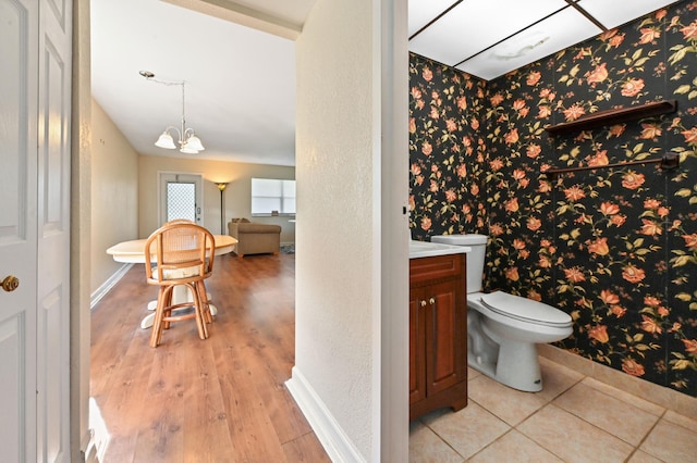 bathroom with vanity, toilet, a chandelier, and hardwood / wood-style flooring