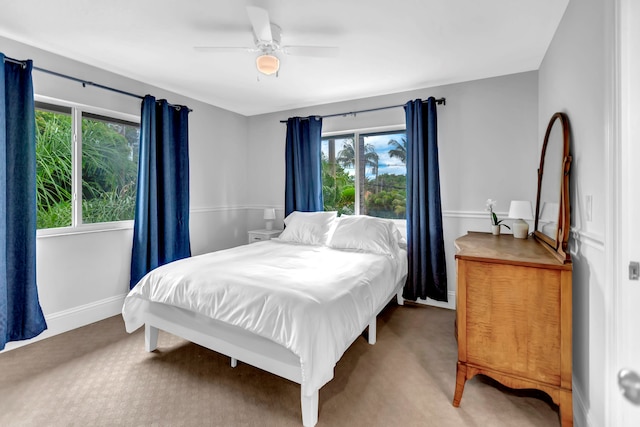 bedroom featuring carpet, multiple windows, and ceiling fan