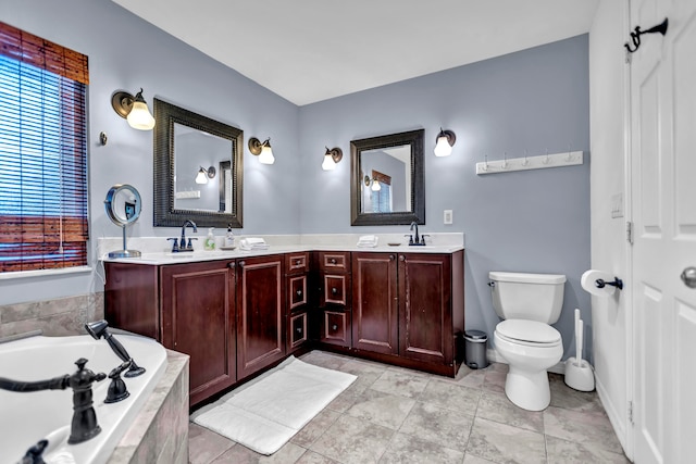 bathroom featuring tile patterned flooring, vanity, toilet, and tiled tub