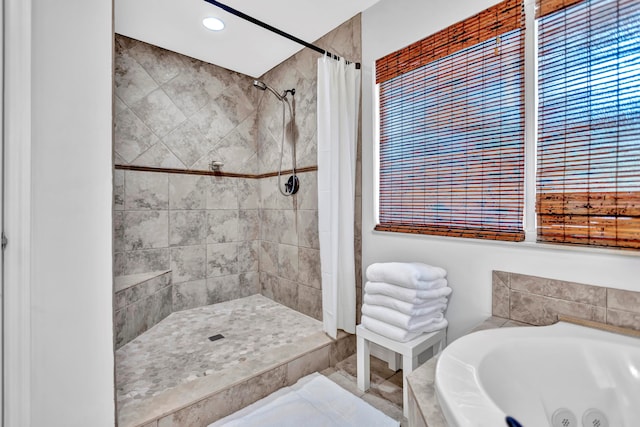 bathroom featuring a wealth of natural light and separate shower and tub