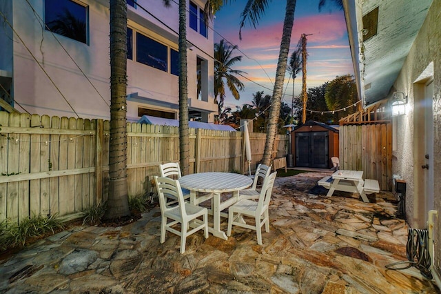 patio terrace at dusk with a storage shed