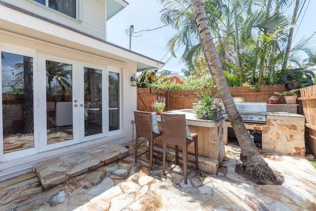 view of patio / terrace featuring french doors and an outdoor kitchen