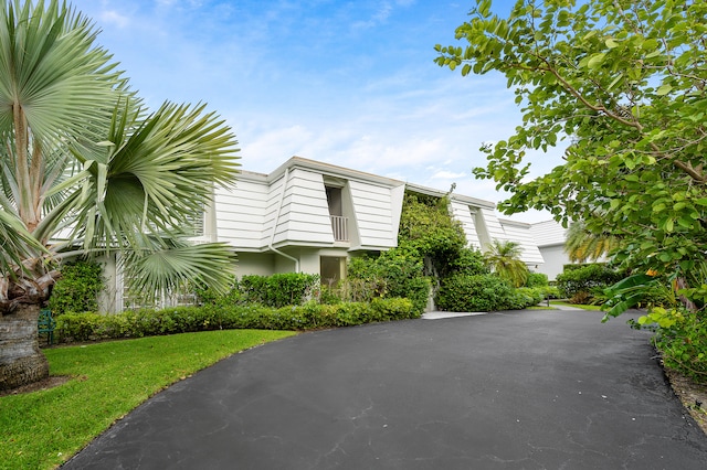 view of property exterior with a yard