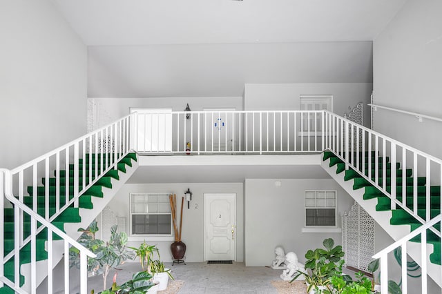 staircase featuring concrete floors