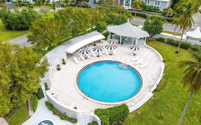 view of pool featuring a lawn and a patio