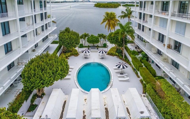 view of pool with a patio and a water view