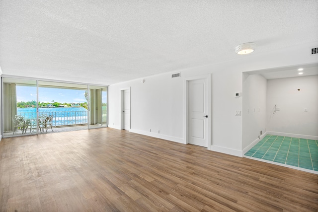 view of swimming pool featuring a water view and a patio