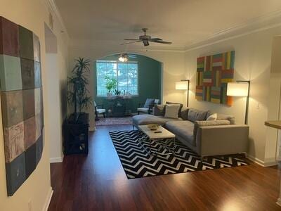 living room featuring ceiling fan, crown molding, and dark hardwood / wood-style flooring