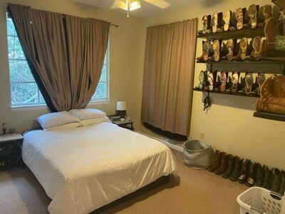 bedroom featuring carpet flooring, multiple windows, and ceiling fan