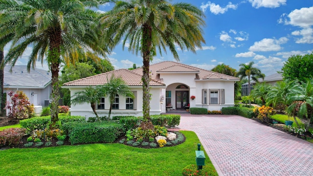 mediterranean / spanish-style home with a front yard