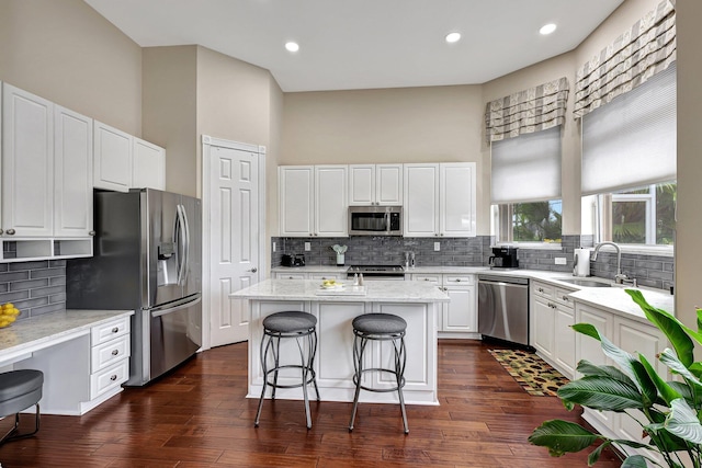 kitchen featuring white cabinetry, dark wood-type flooring, stainless steel appliances, and sink