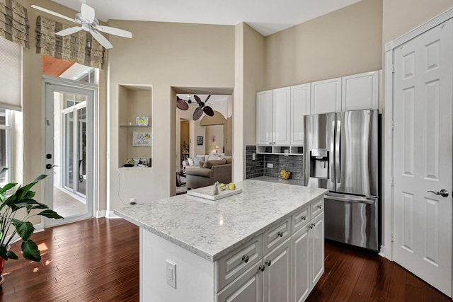 kitchen featuring stainless steel fridge, white cabinetry, and dark wood-type flooring